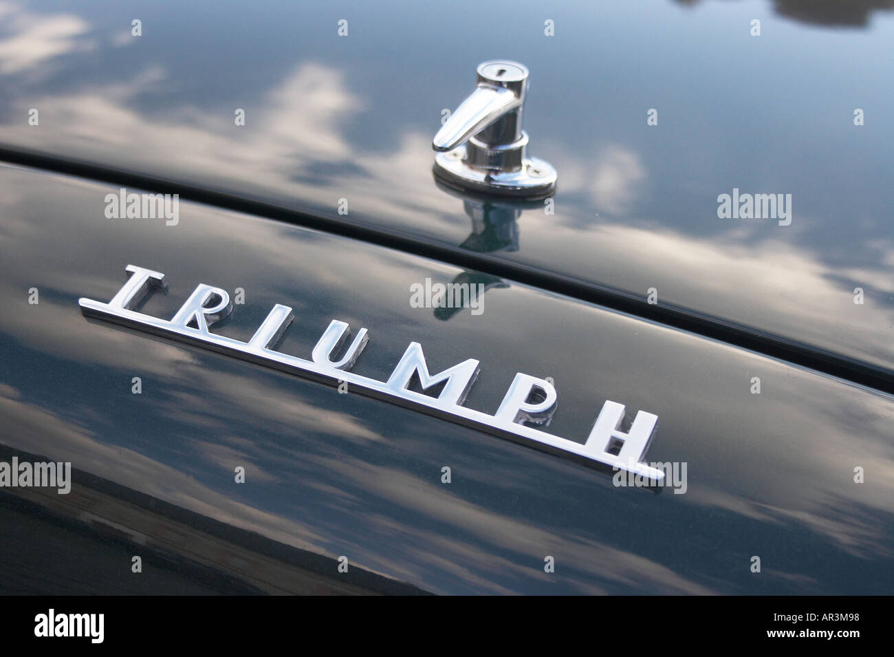 logo sign of Triumph oldtimer car with cloud reflection on paint Stock ...