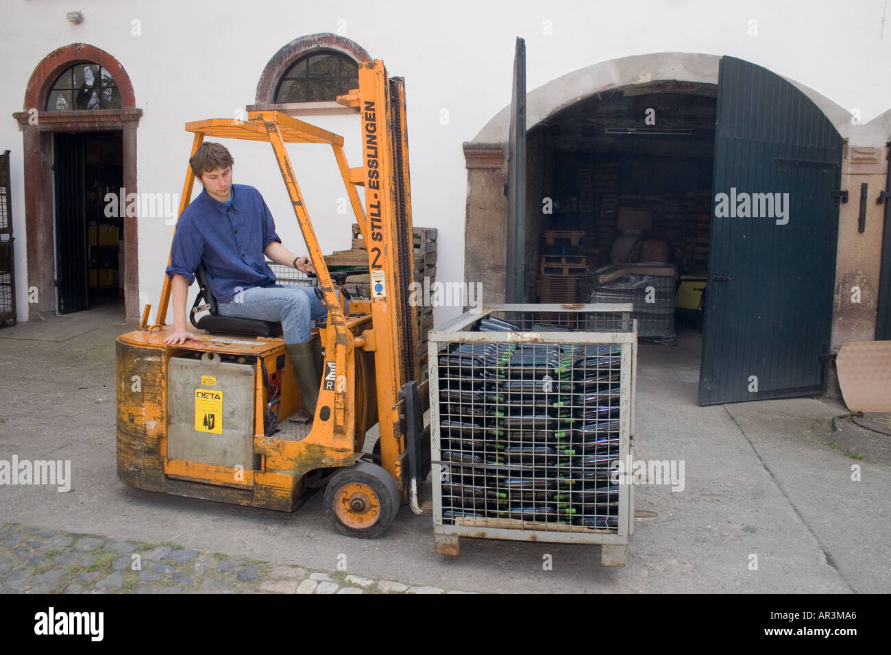 Wine bottling bottle with mobile equipment cellarmaster drives freshly filled bottles into warehouse Stock Photo