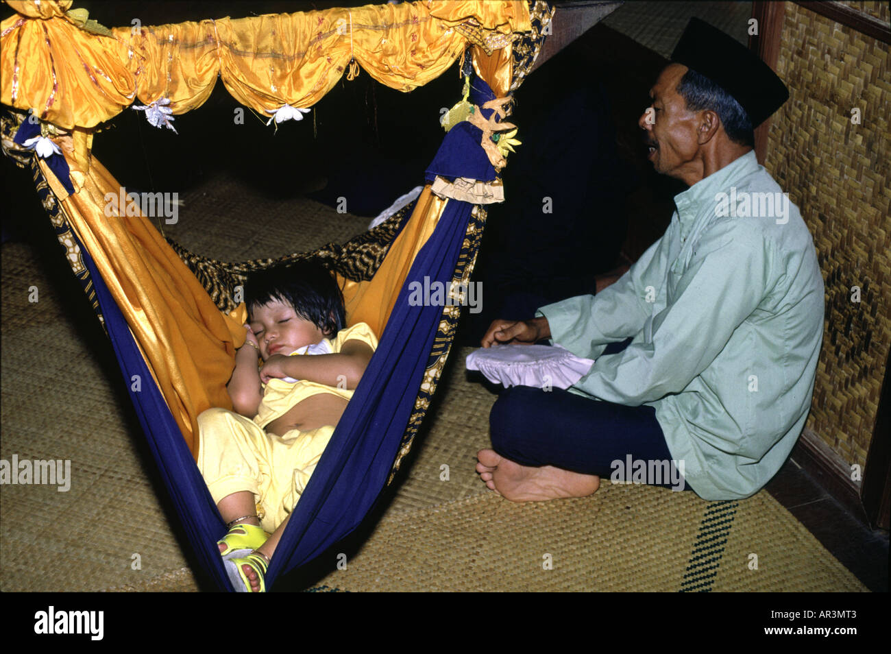 Man singing a child to sleep, Penang, Malaysia, Asia Stock Photo