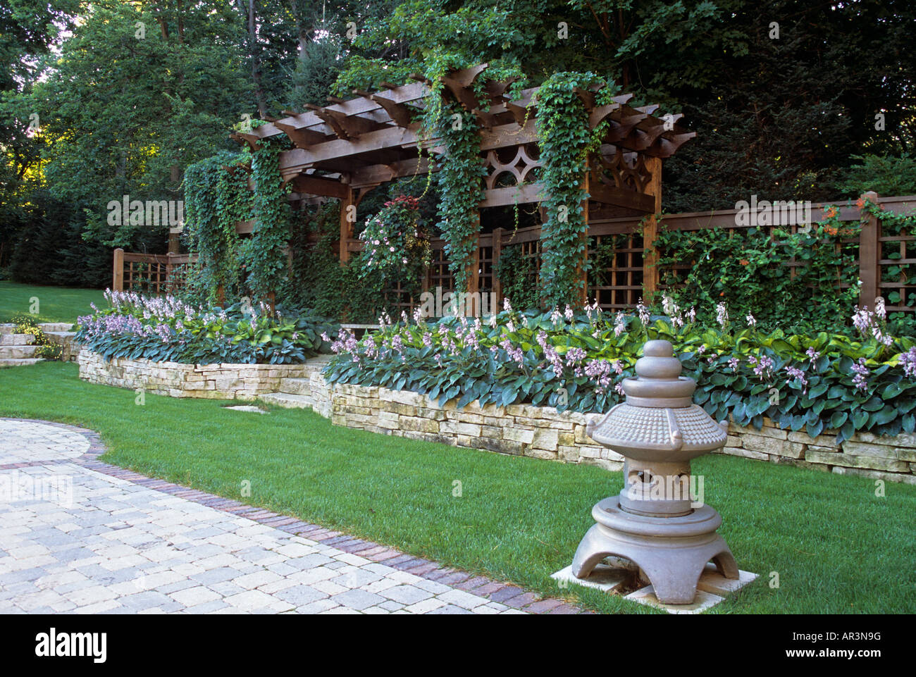 WOOD SIDE ARBOR, LOW BRICK WALL AND BORDER GARDEN OF HALYCON, FRANCES ...