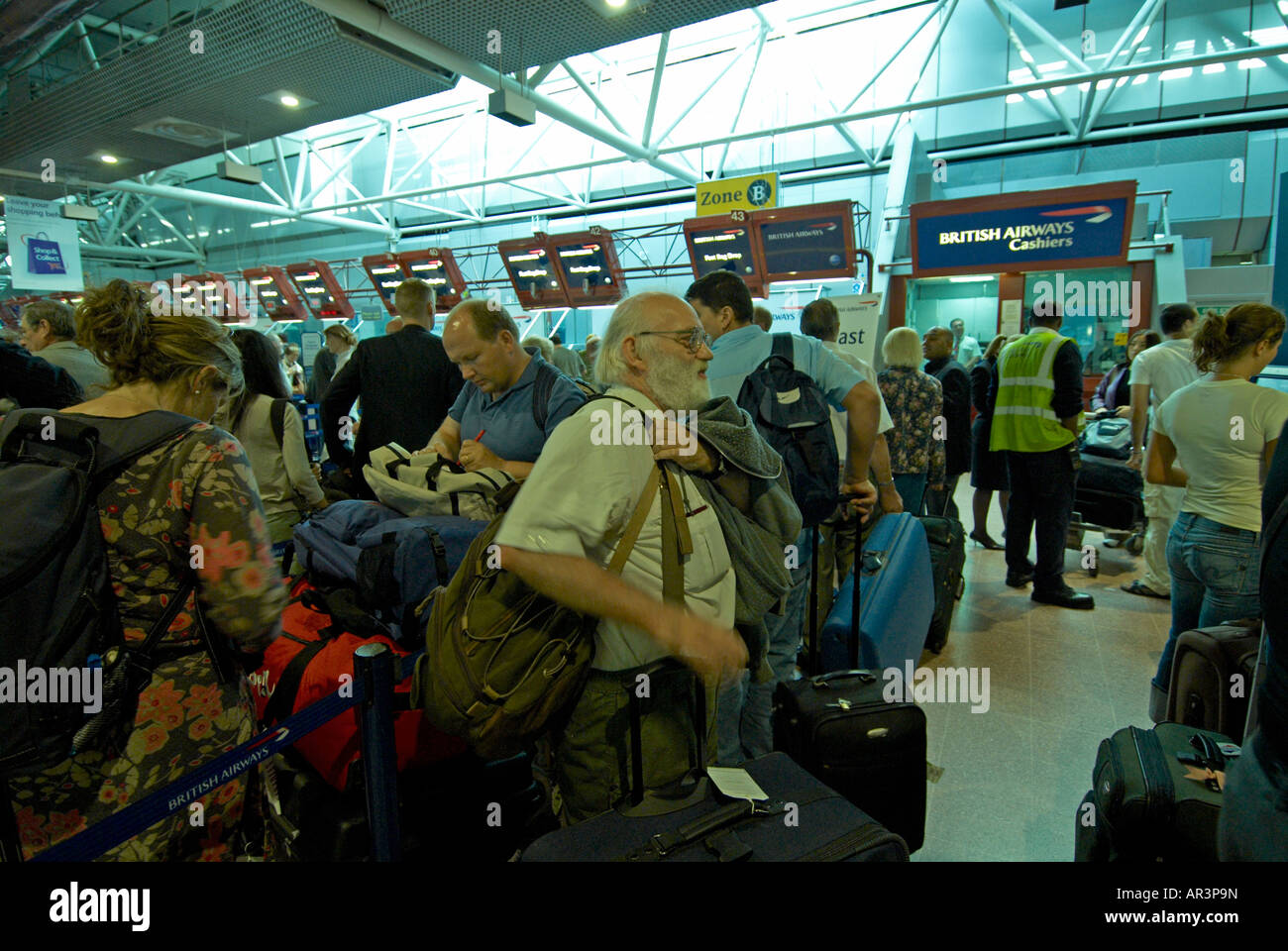 Passengers waiting in line for check in BAA London Heathrow Stock Photo