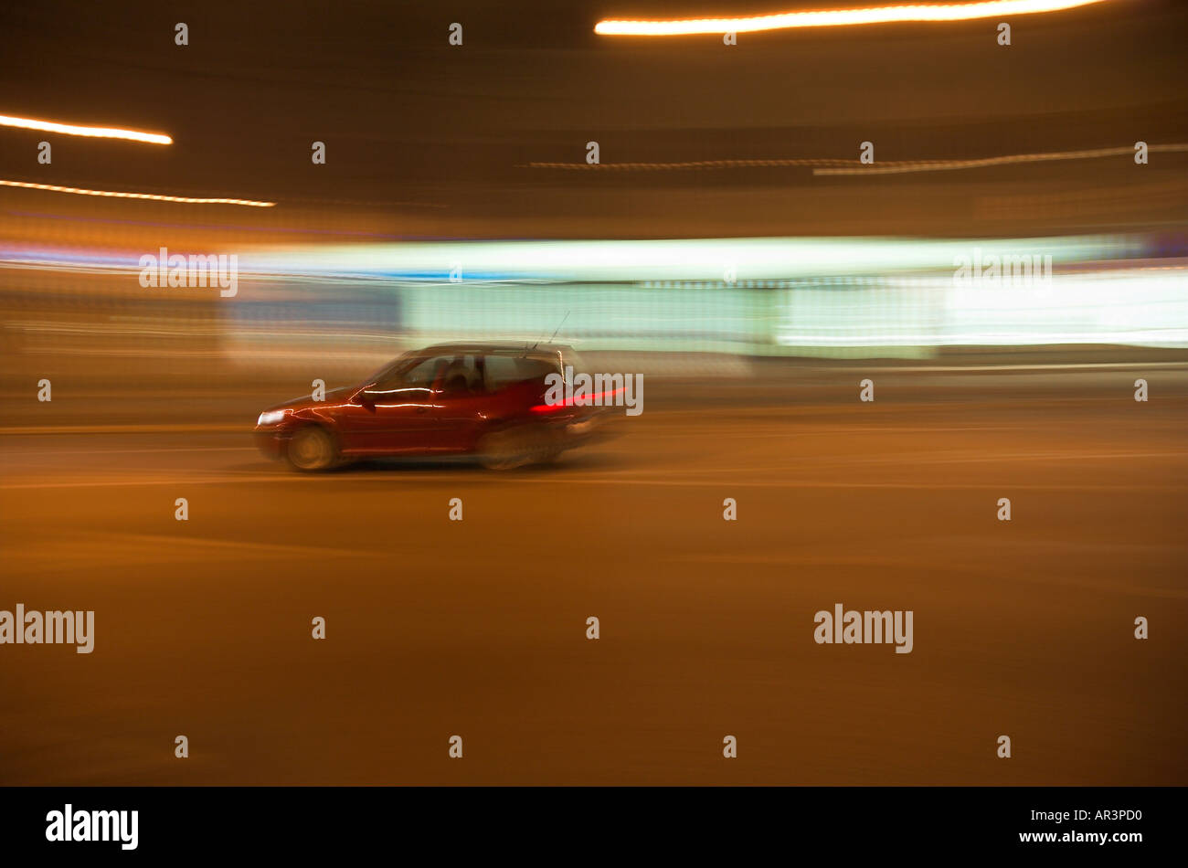 Car at night on street in blurred motion Stock Photo - Alamy