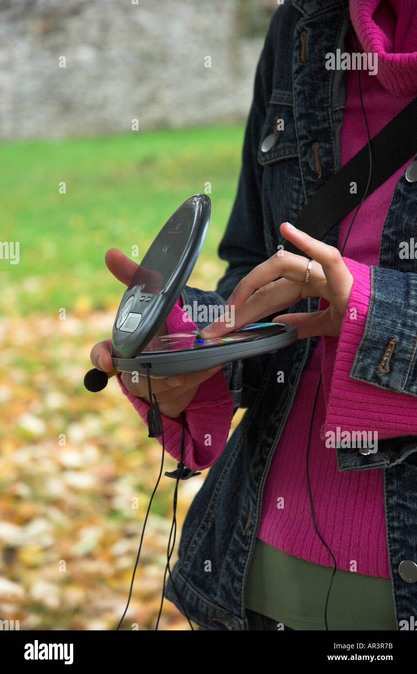 Young woman in park listening music Stock Photo