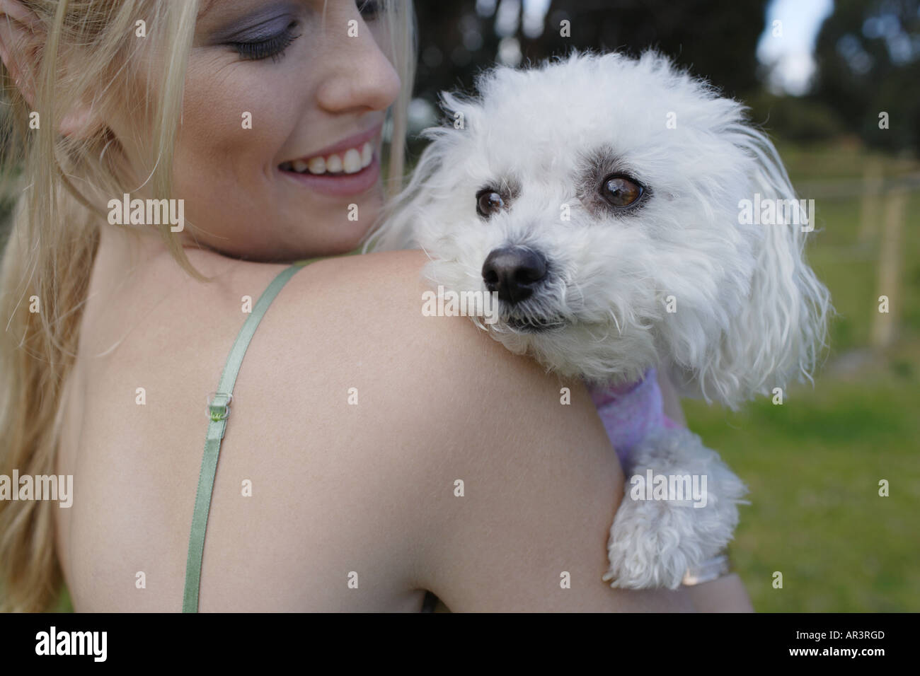 Young woman and pet dog in park Stock Photo