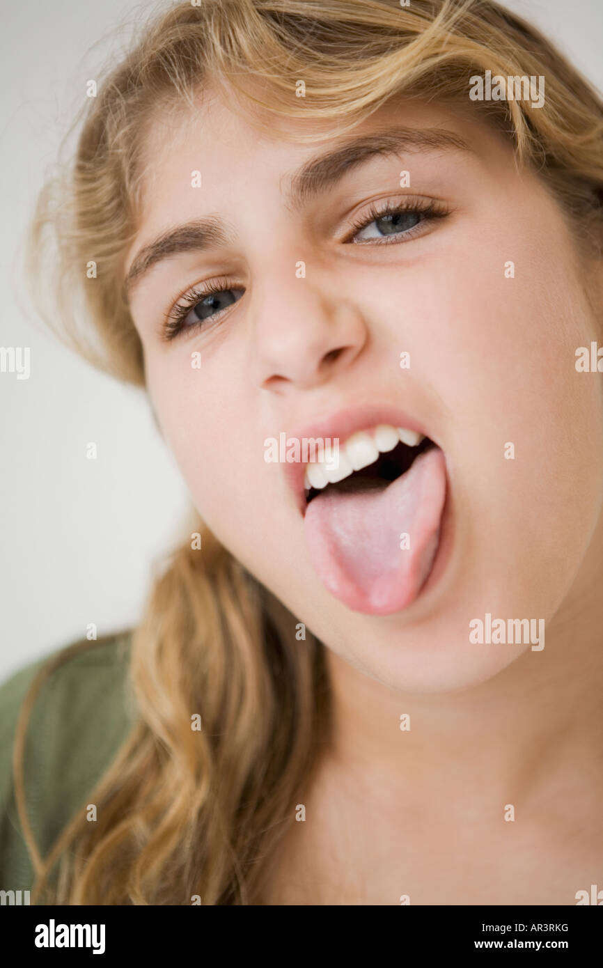 Close up of girl sticking out tongue Stock Photo