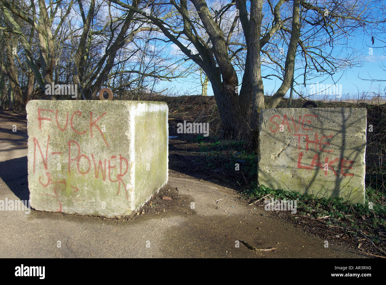 Graffiti on concrete bollards across a path at Radley Lakes Abingdon