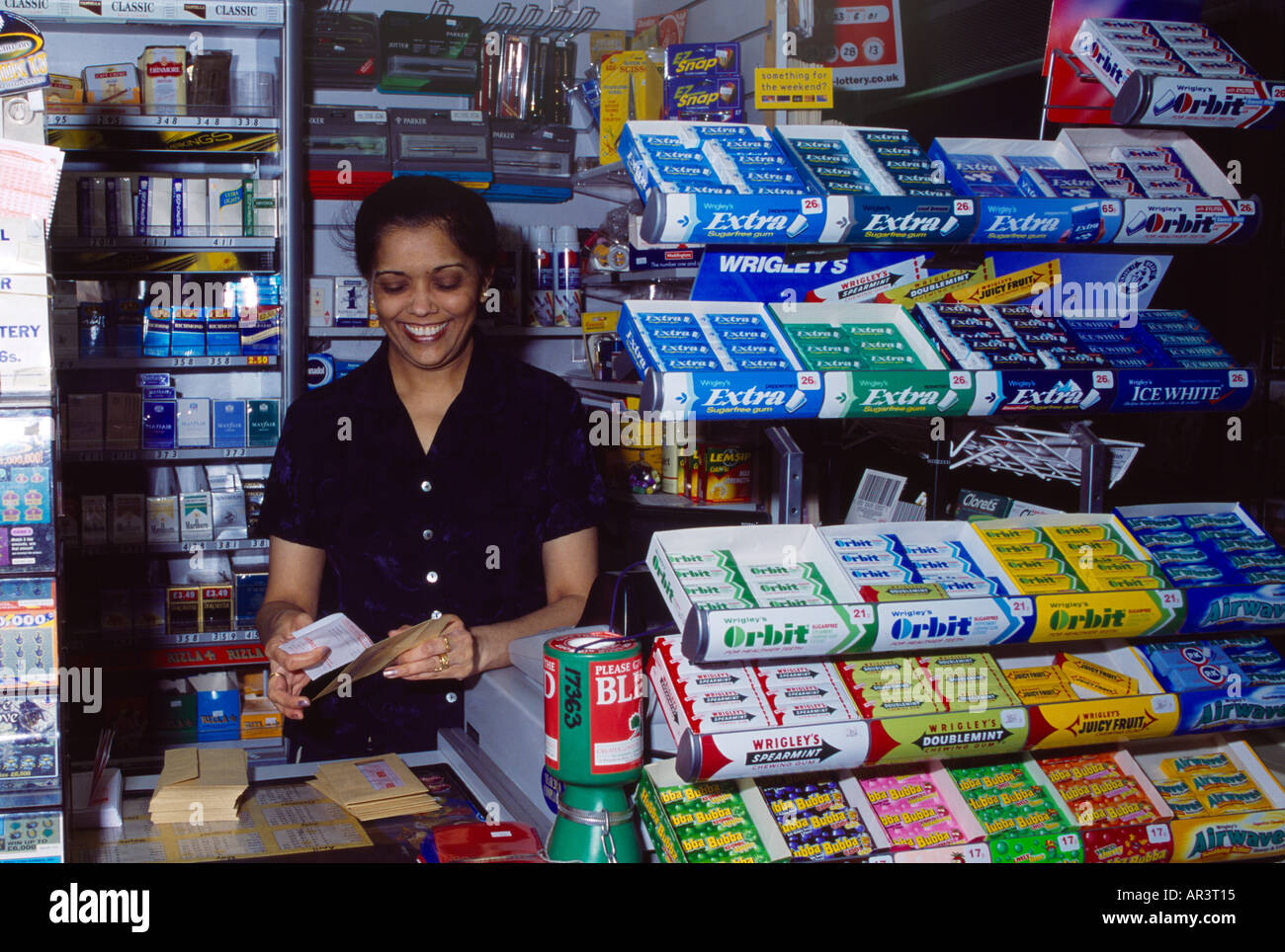 Newsagent Asian Woman Working in Shop Stock Photo