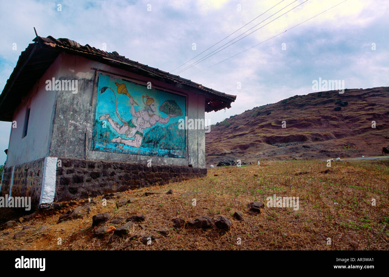 Nr. Alibag India Hanuman Carrying the Gada and Dronagiri Parvat Painted On Hut By Roadside Stock Photo