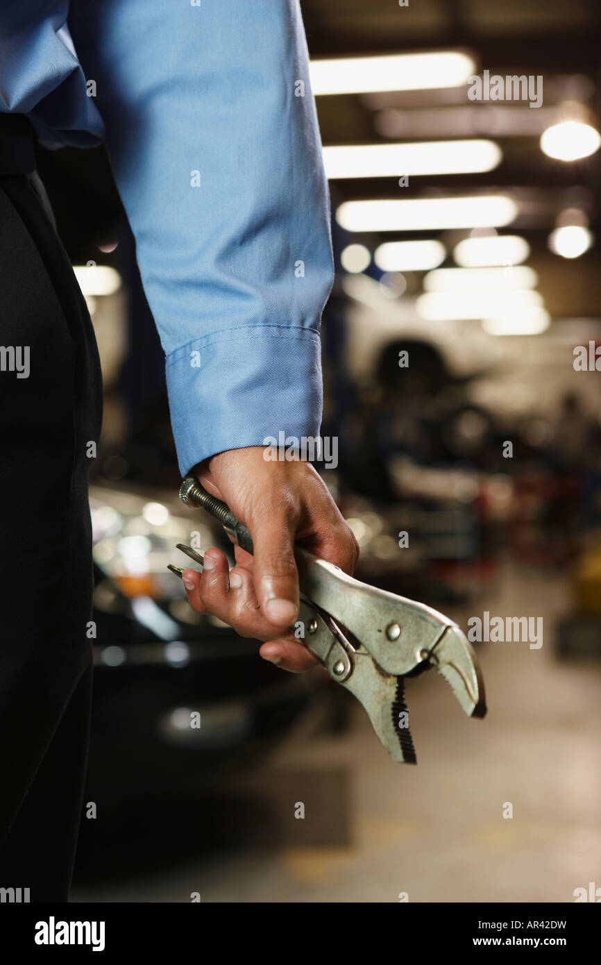 Male auto mechanic holding vice grips Stock Photo Alamy