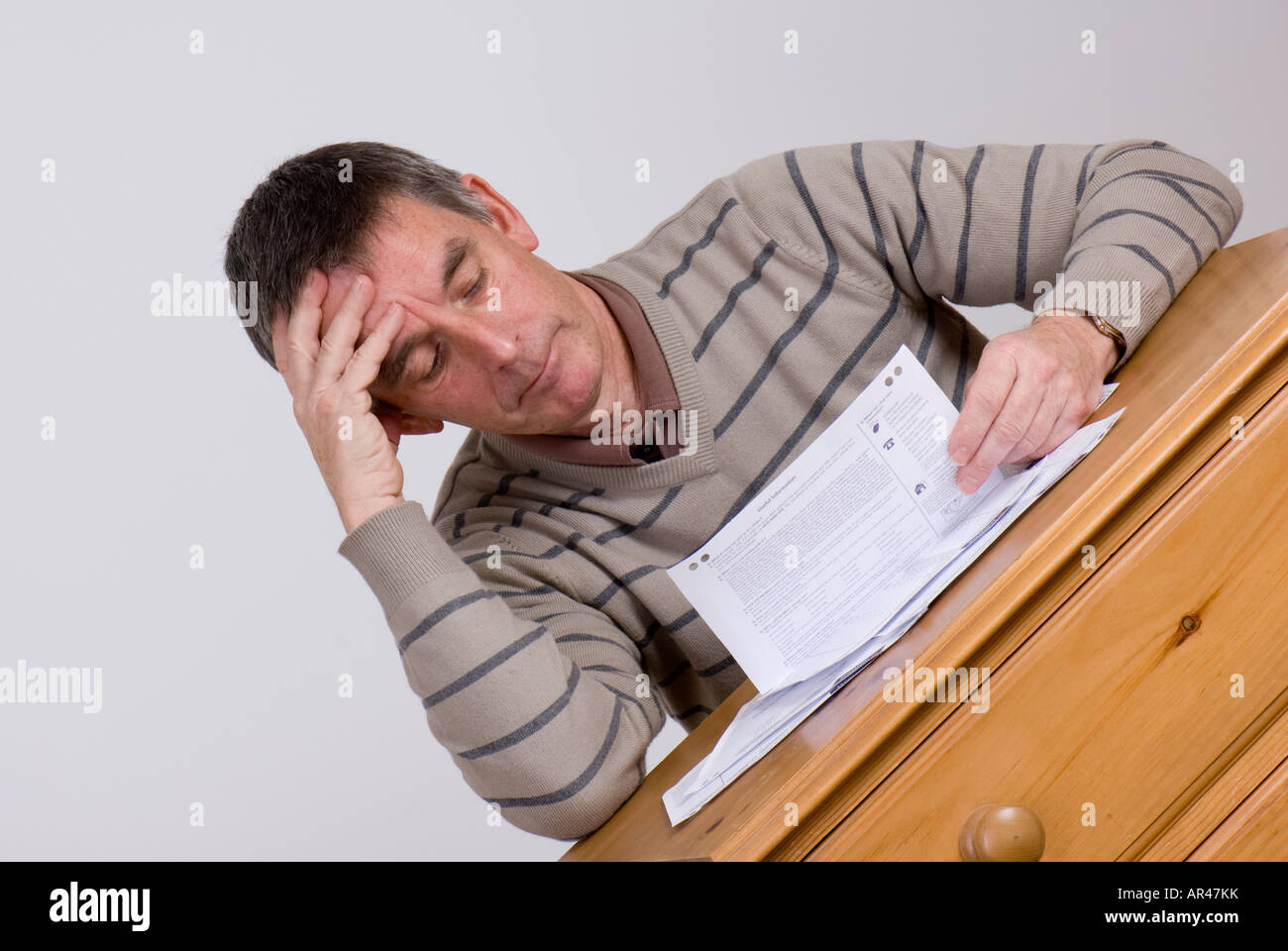 mature man worried debt problems bank statements budget problems bad news money worries Stock Photo