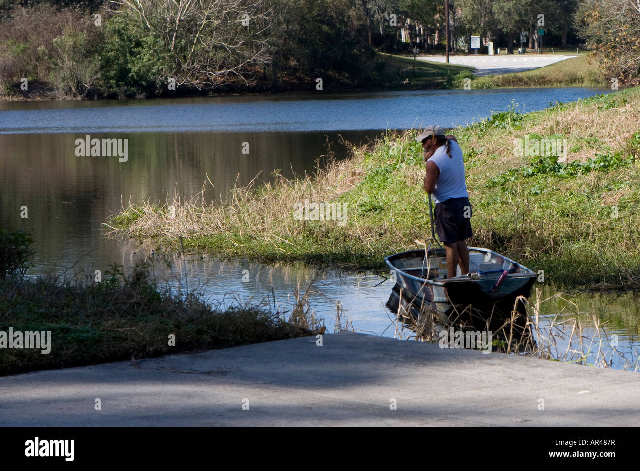 Man Standing in a Boat Fishing Stock Photo - Alamy