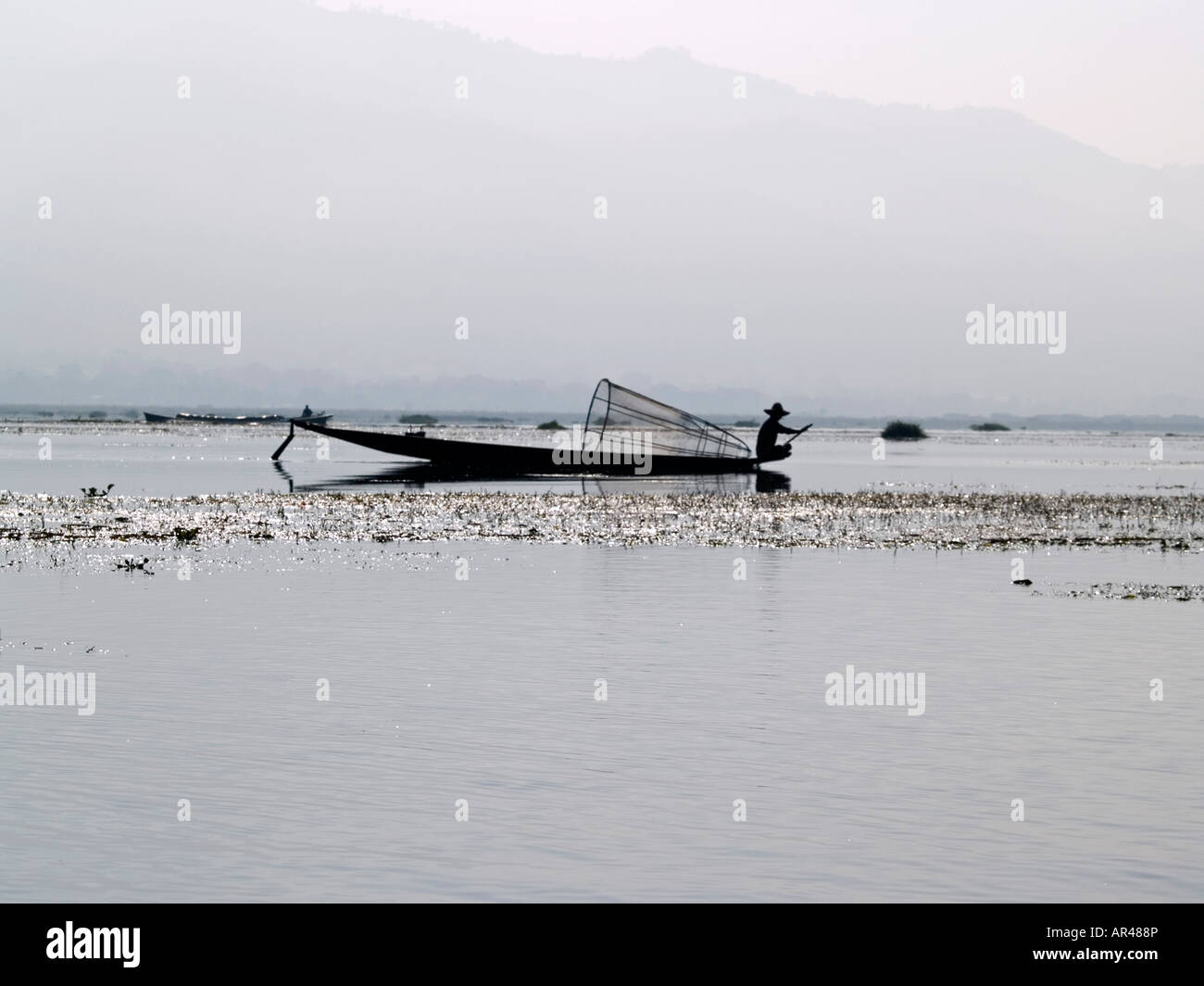 silhouette of Burmese fisherman on Inle Lake in Myanmar Stock Photo - Alamy