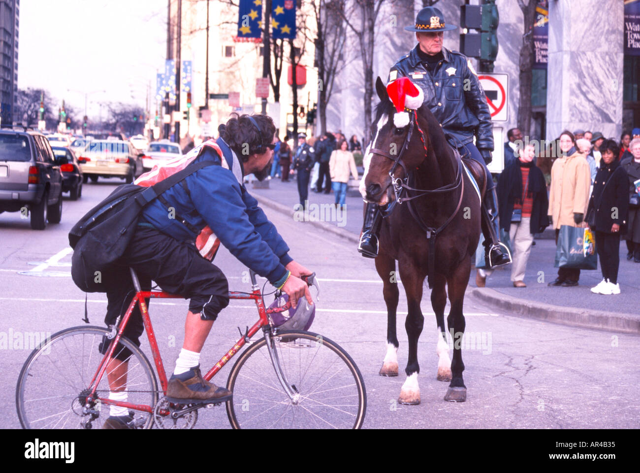 Mounted police officer and bicycle messenger Horse appears to be talking to bike messenger Michigan Avenue Chicago Illinois USA Stock Photo