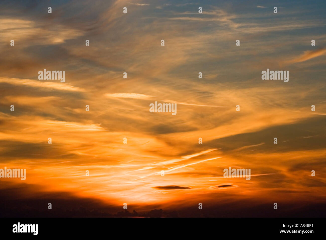 Aircraft con trails. Sunset over southern England. UK.  Rich colours. Aerial view coming in to land. Stock Photo