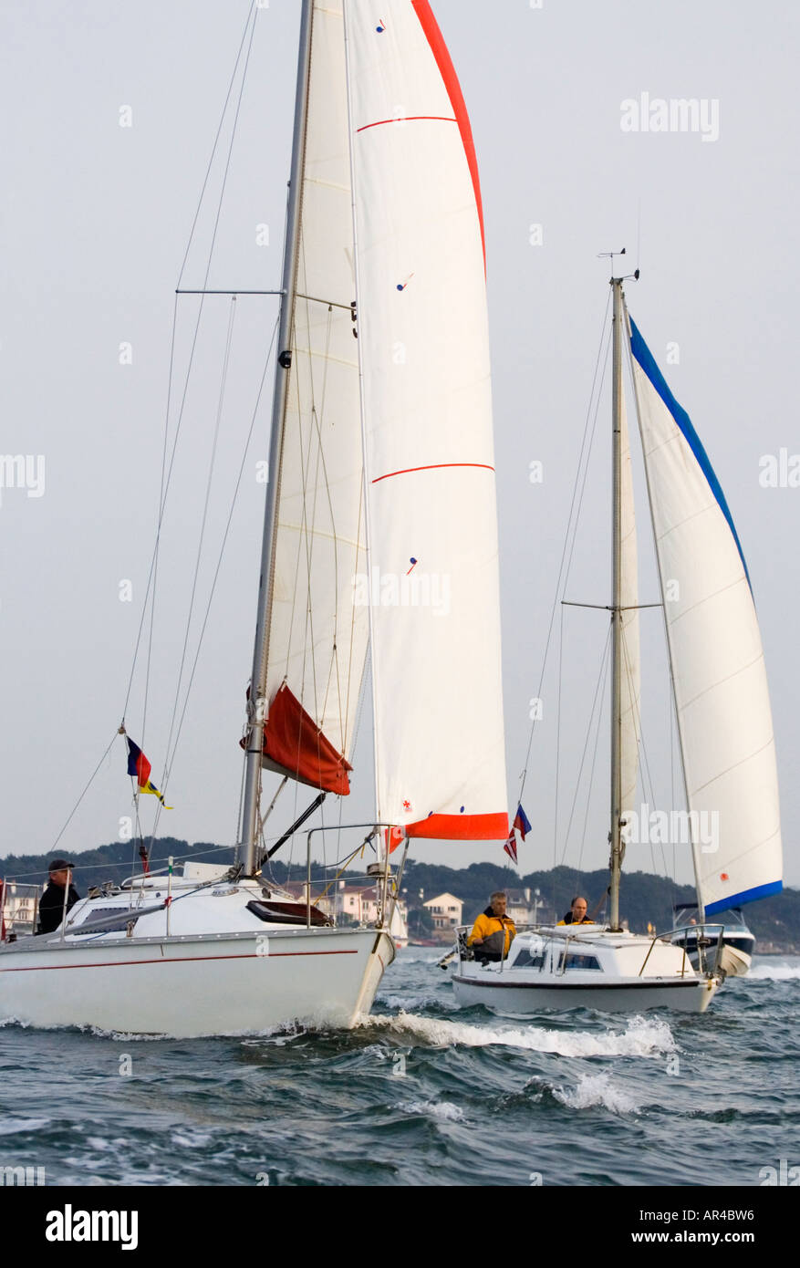 Two sailing boats in choppy water. Poole harbour. Dorset. UK Stock