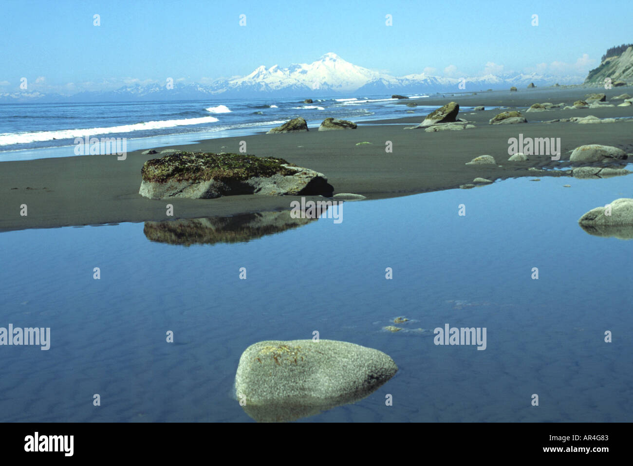 Tidal pool near Homer, Alaska, with Cook Inlet and Iliamna volcano in the background. Stock Photo