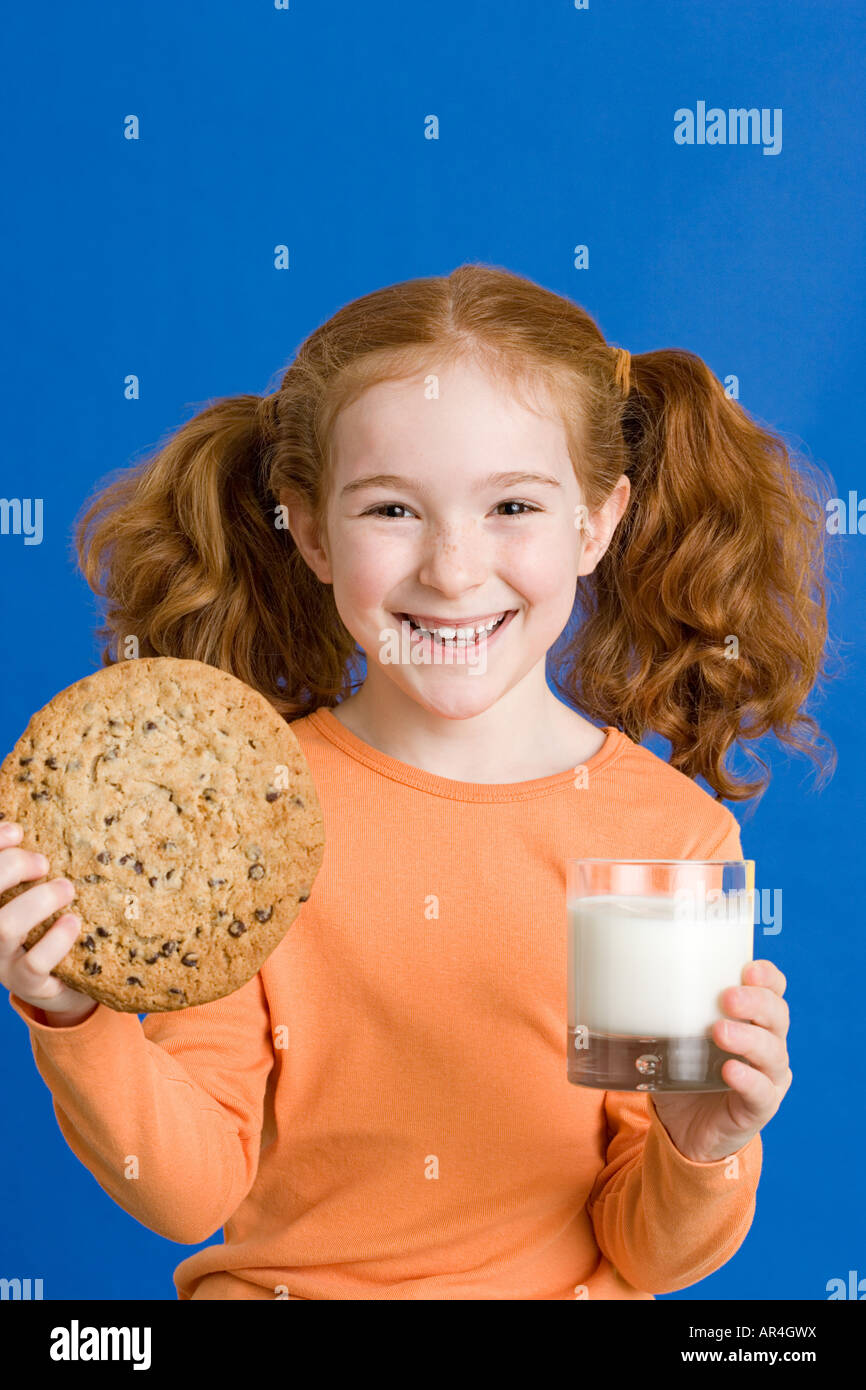 Girl with milk and cookie Stock Photo Alamy