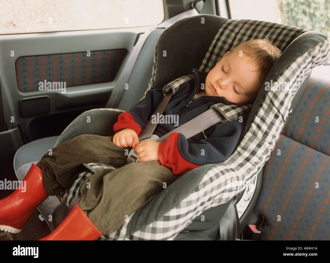Toddler asleep in car seat Stock Photo Alamy