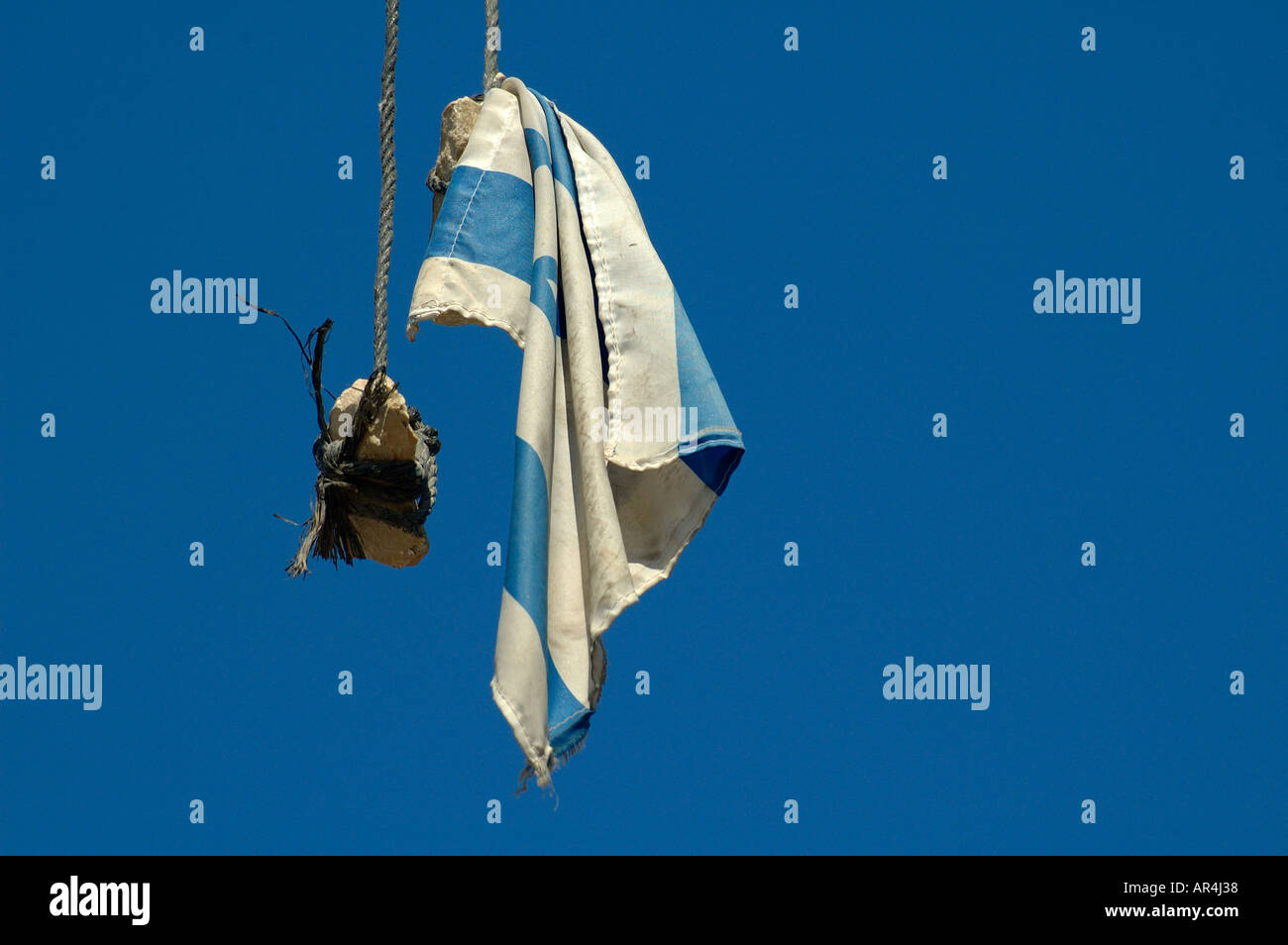 Israeli flag attached to piece of rock hanging off electric cable in East Jerusalem during Intifada riots. Israel Stock Photo