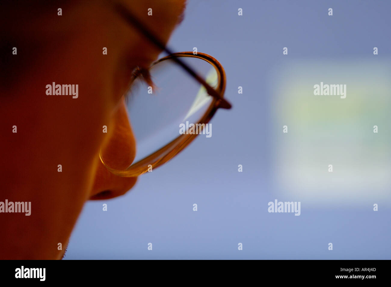 Man looking at a computer screen Stock Photo