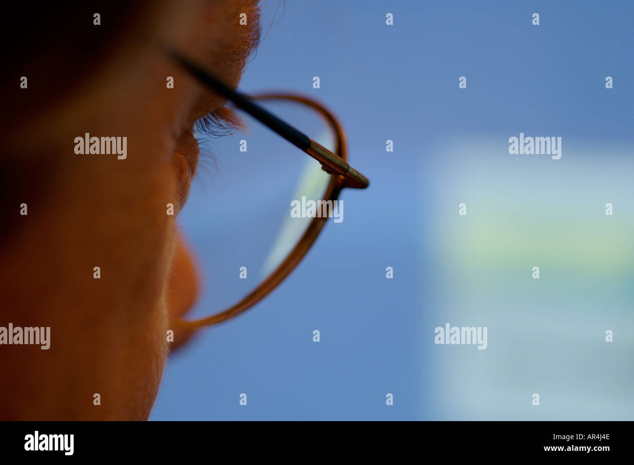 Man looking at a computer screen Stock Photo
