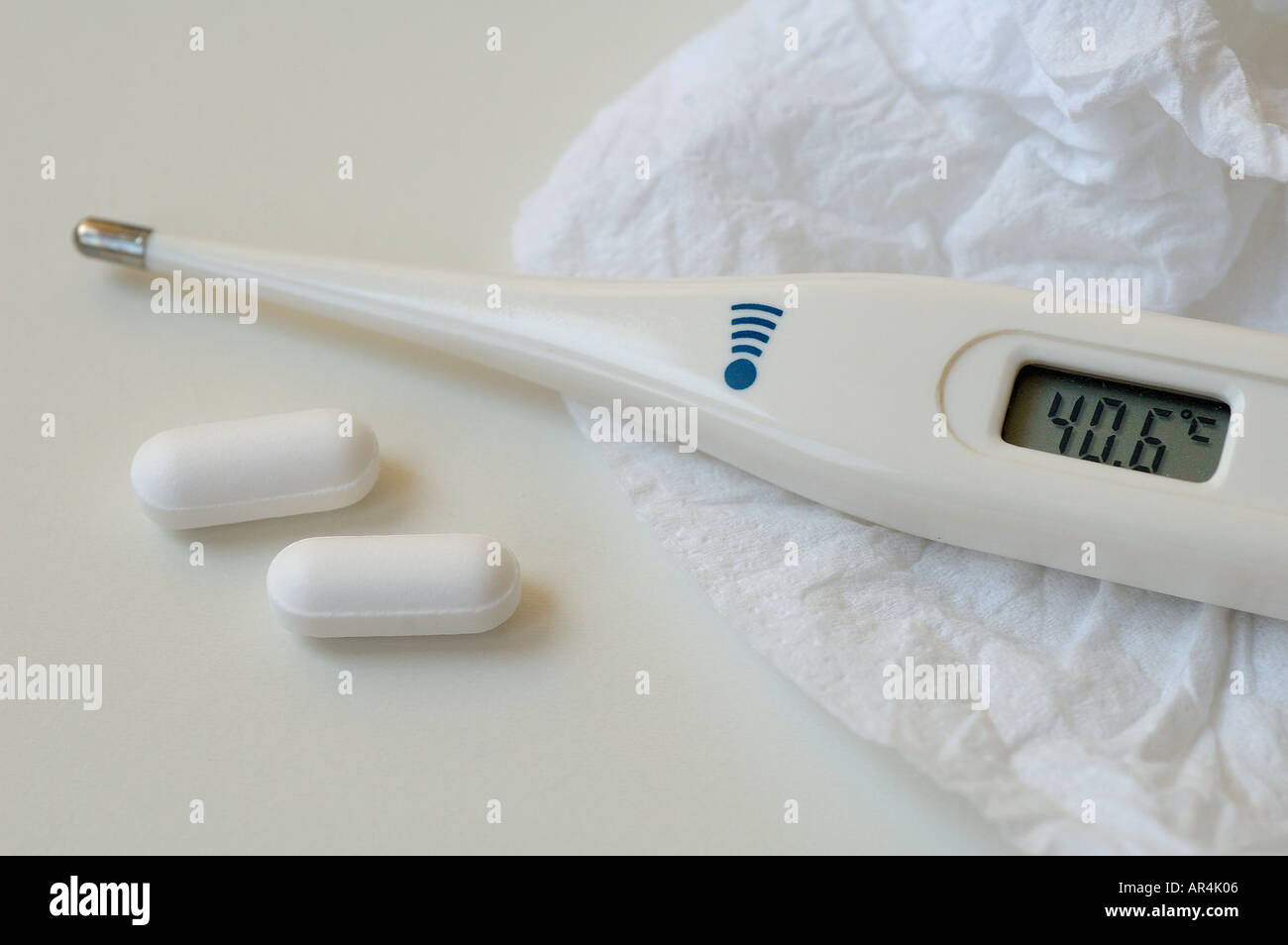 Digital electronic clinical thermometer with medical pills Stock Photo