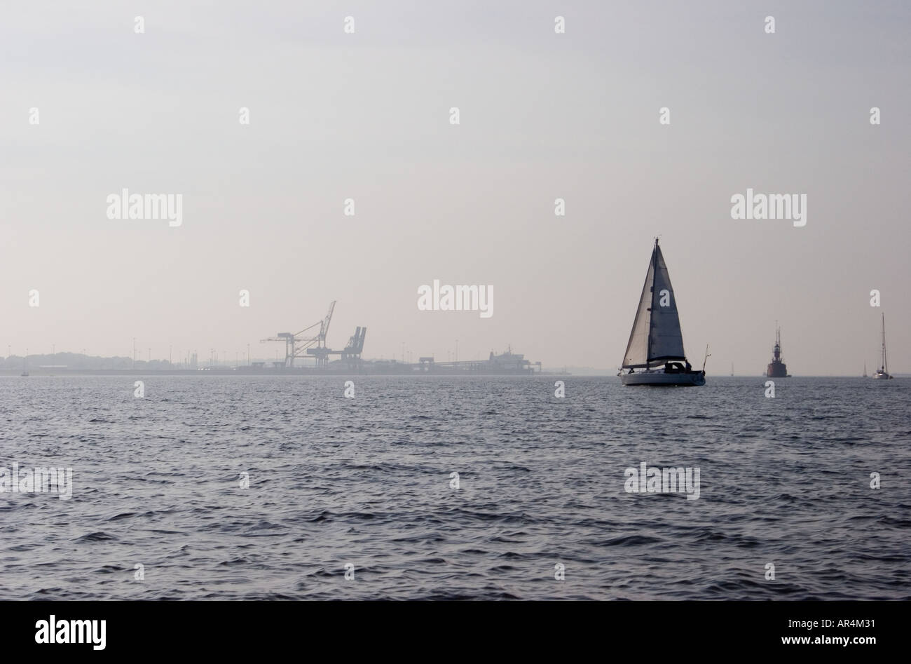 colour image off looking across the sea with a boat sailing in the ...