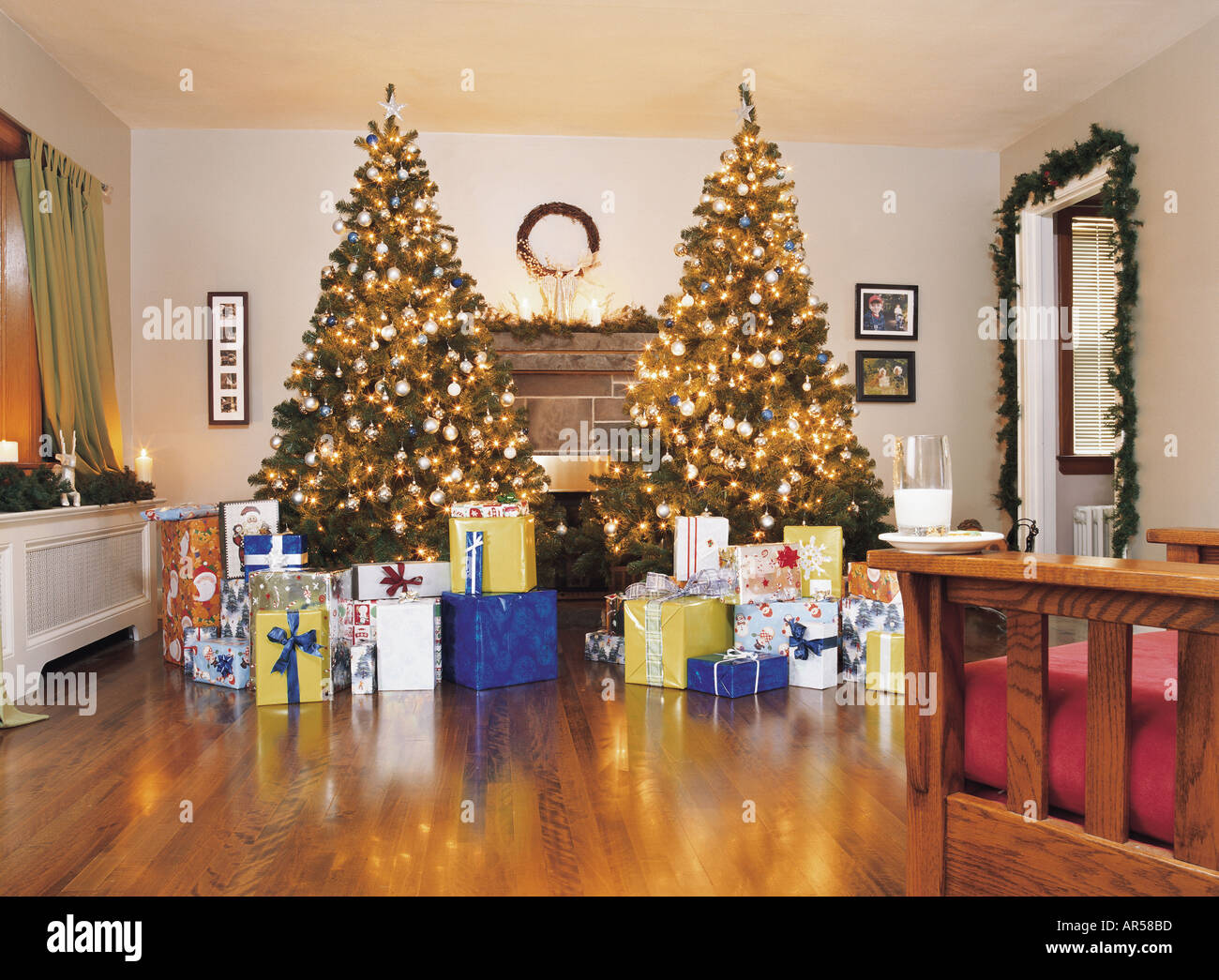 Two christmas trees in a living room with presents Stock Photo Alamy