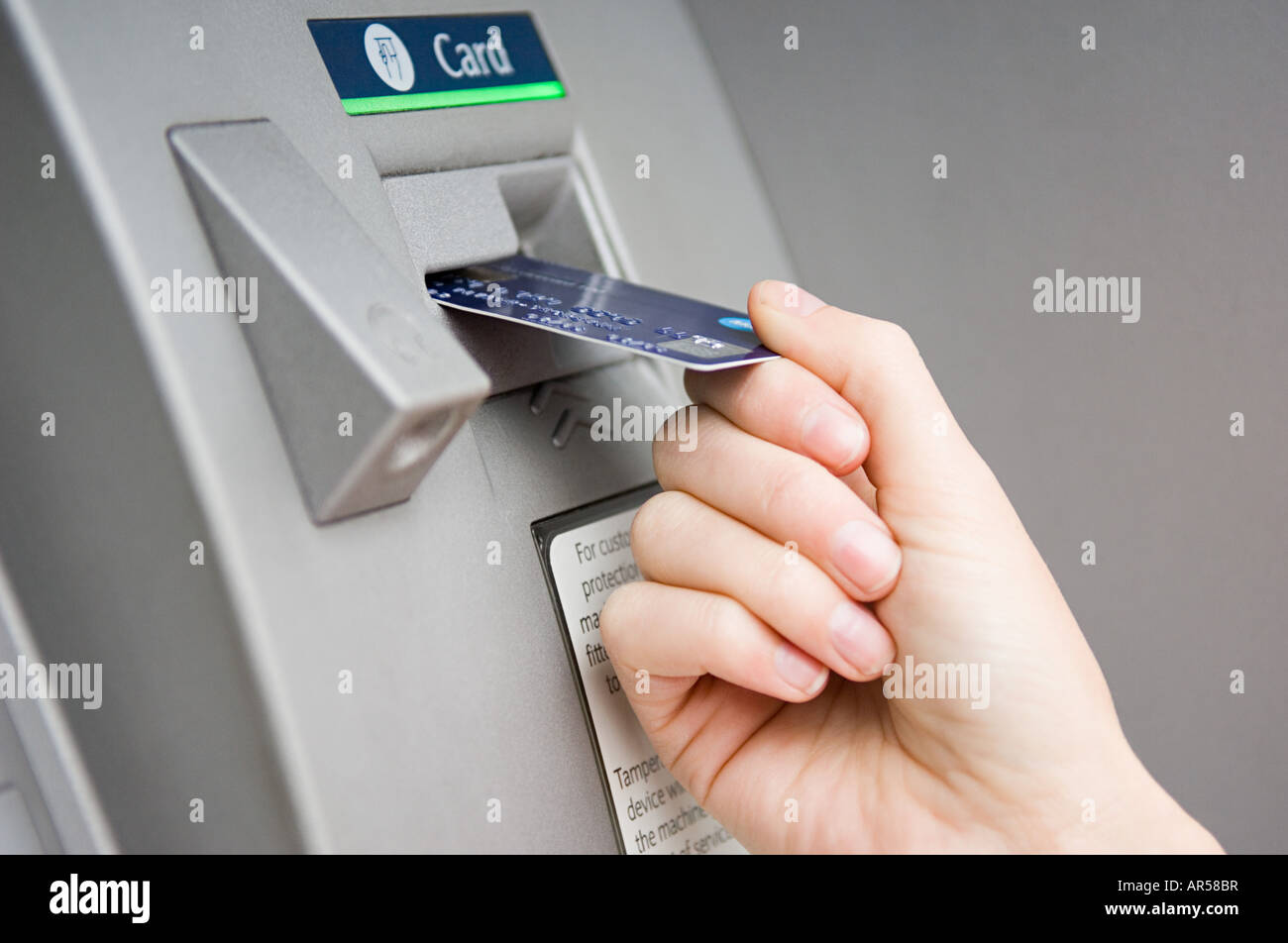 Person puttting card into cash machine Stock Photo - Alamy