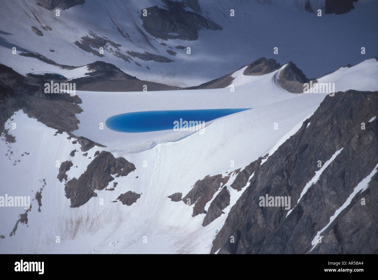 Pond of meltwater on glacial ice and snow Chigmit mountains Lake Clark National Park Alaska USA Stock Photo