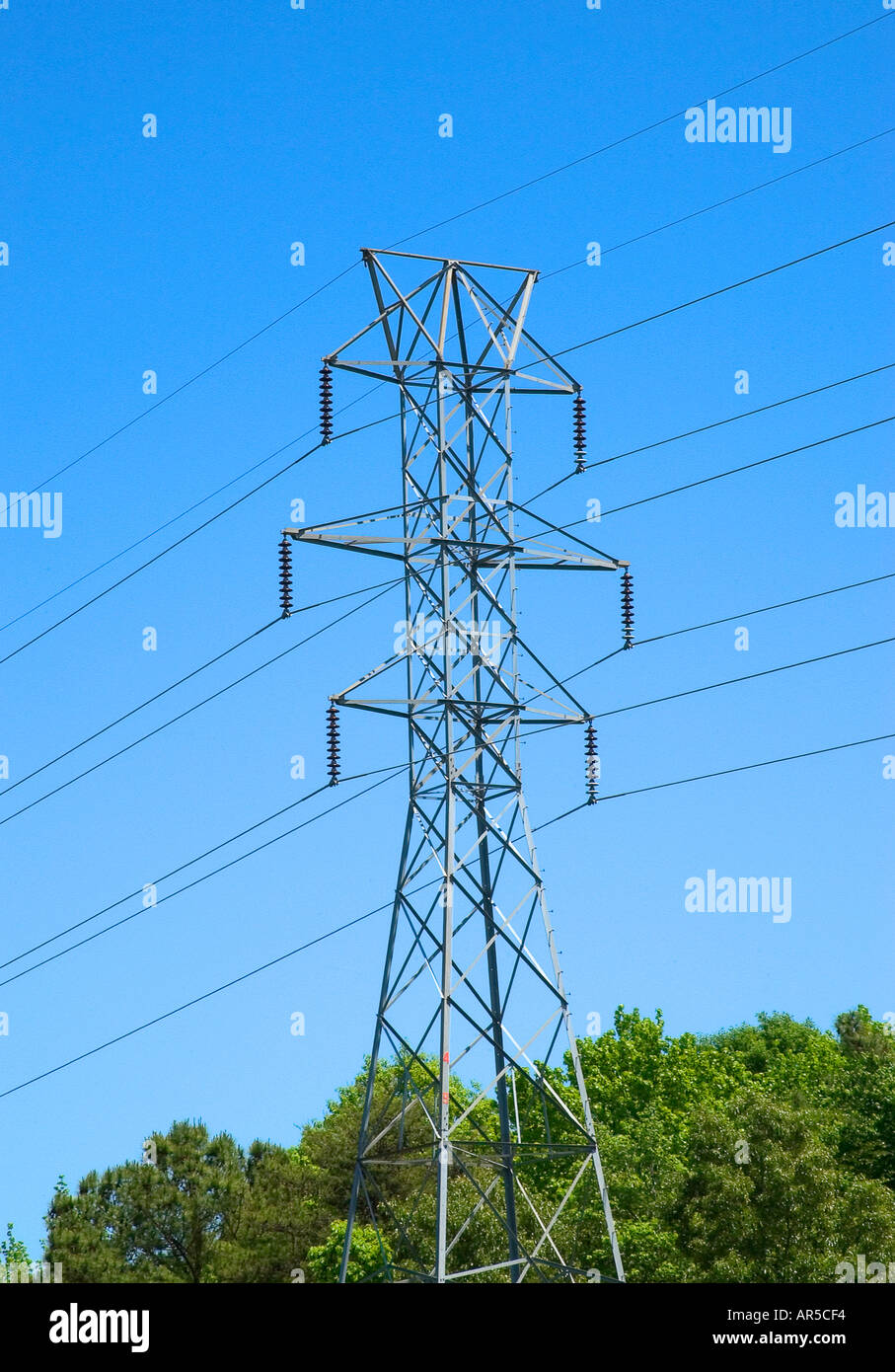 High-voltage electric transmission tower with power lines stretching ...