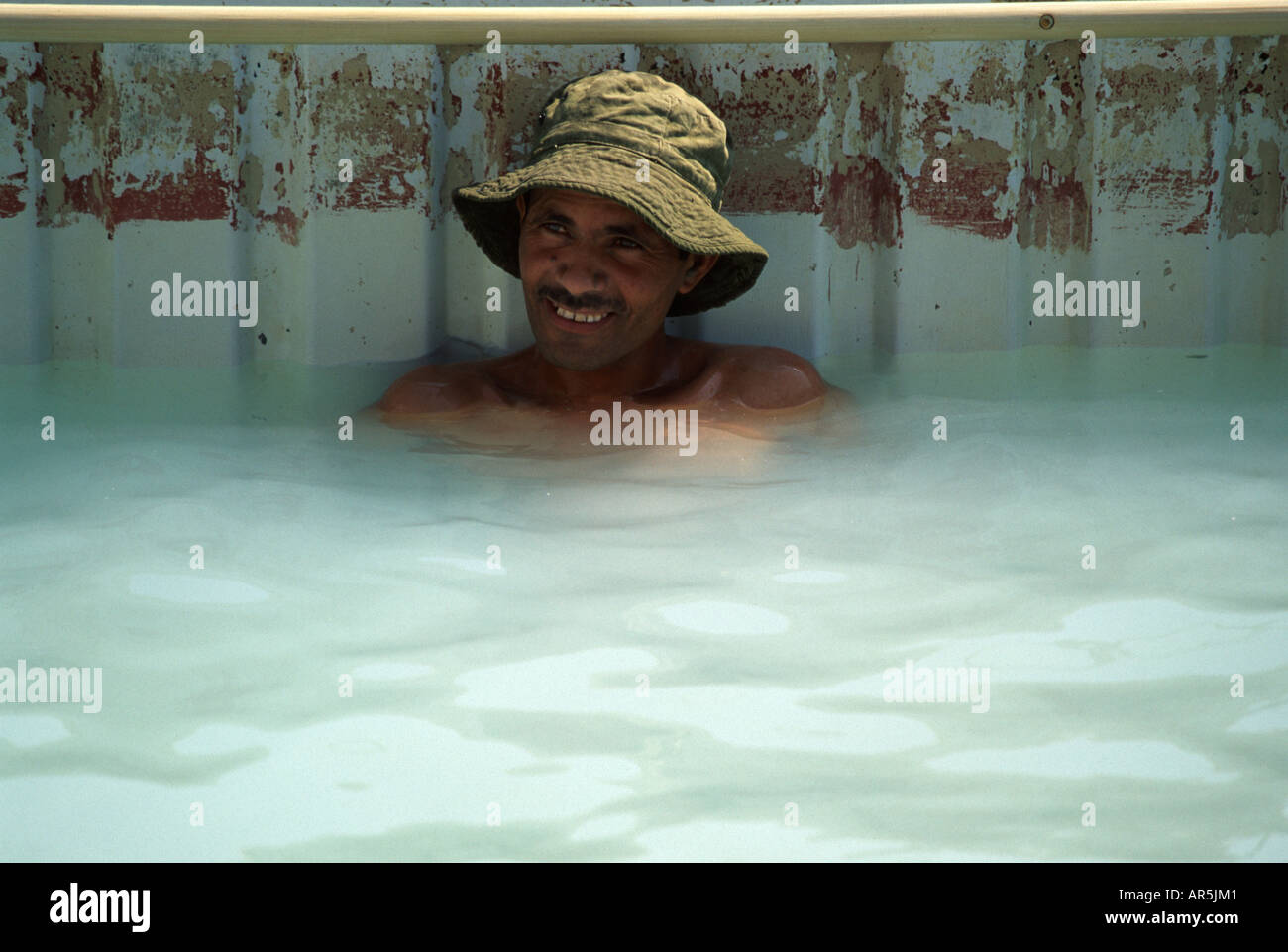 Palestinian man in a salt water pool, Dead Sea Israel Stock Photo