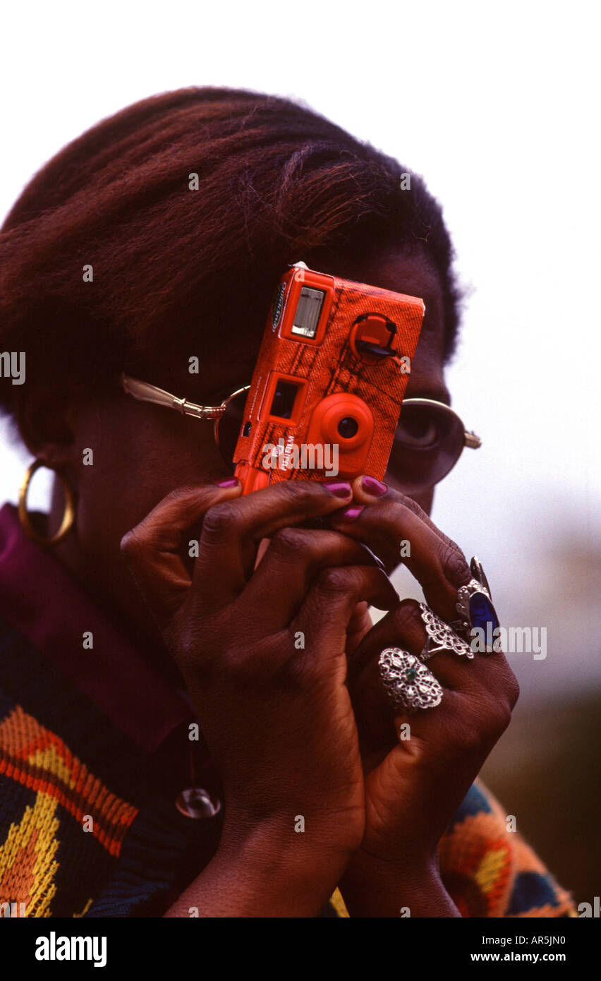 Afro american tourist taking snap shot with plastic camera Stock Photo