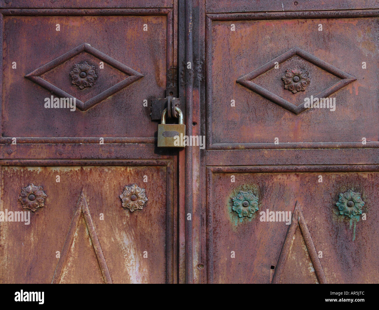 Timeworn old rusty metal door with carving decorations and padlock Stock Photo Alamy
