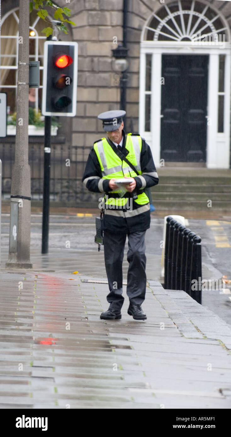 Traffic warden patrolling Charlotte Square, Edinburgh Stock Photo