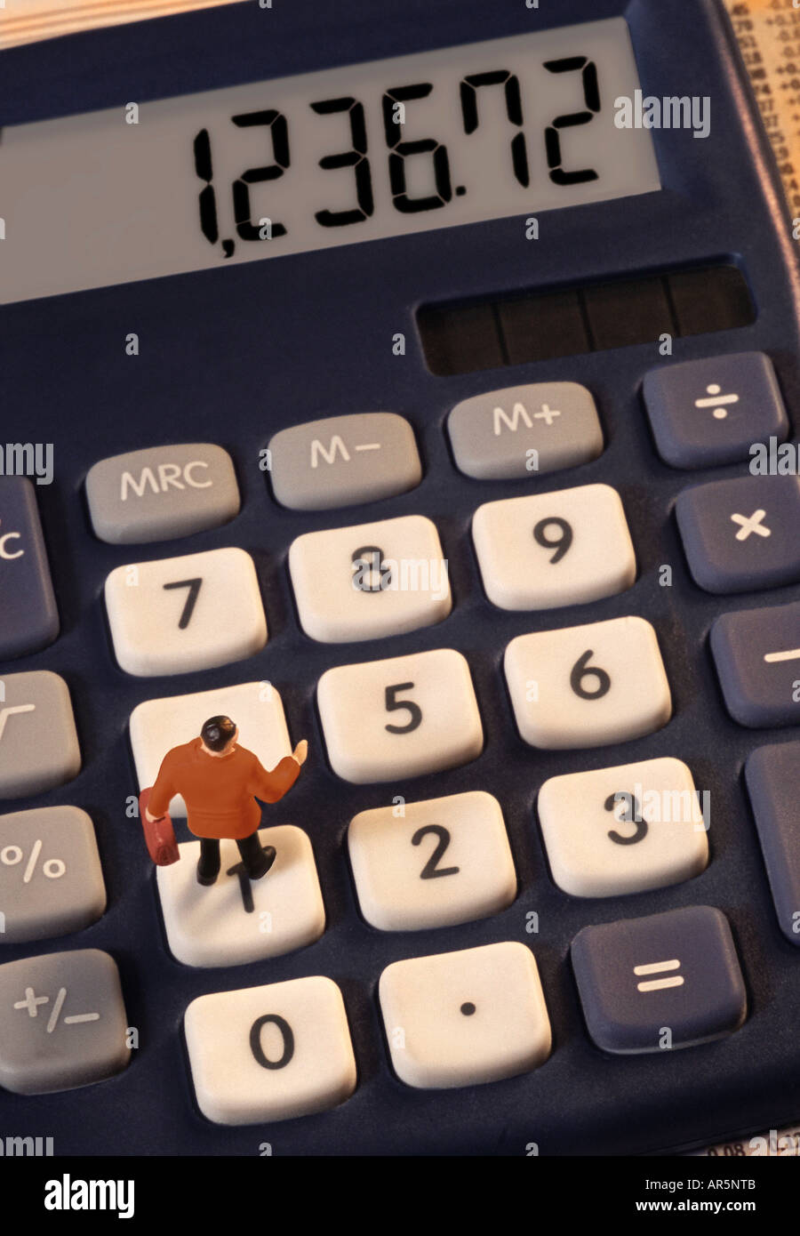Toy businessman figurine on calculator Stock Photo