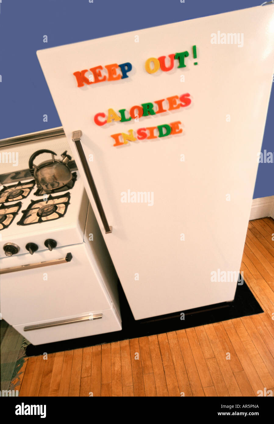 Refridgerator with letters spelling keep out calories inside Stock Photo