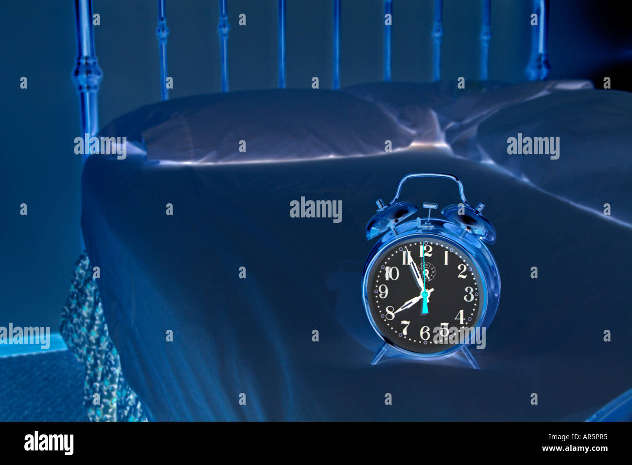 Analog alarm clock on bed Stock Photo Alamy
