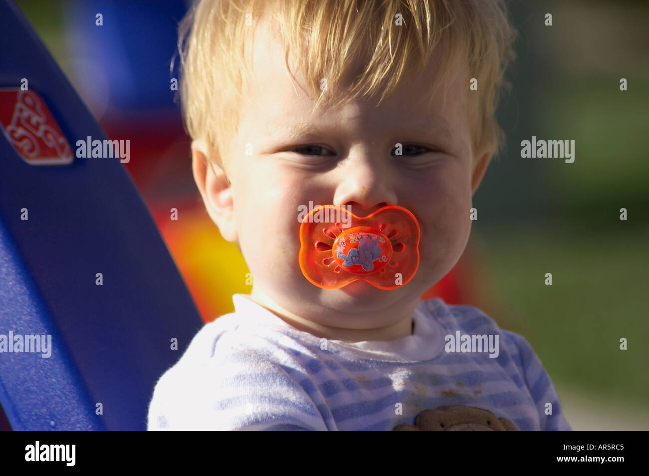 dirty baby with pacifier Stock Photo