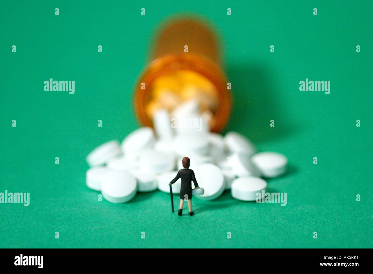 Toy figurine standing in front of bottle of pills Stock Photo Alamy