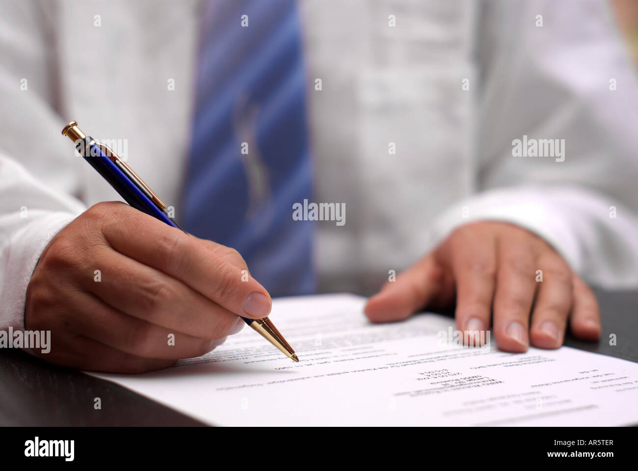 Office desk with business man signing a contract Stock Photo - Alamy