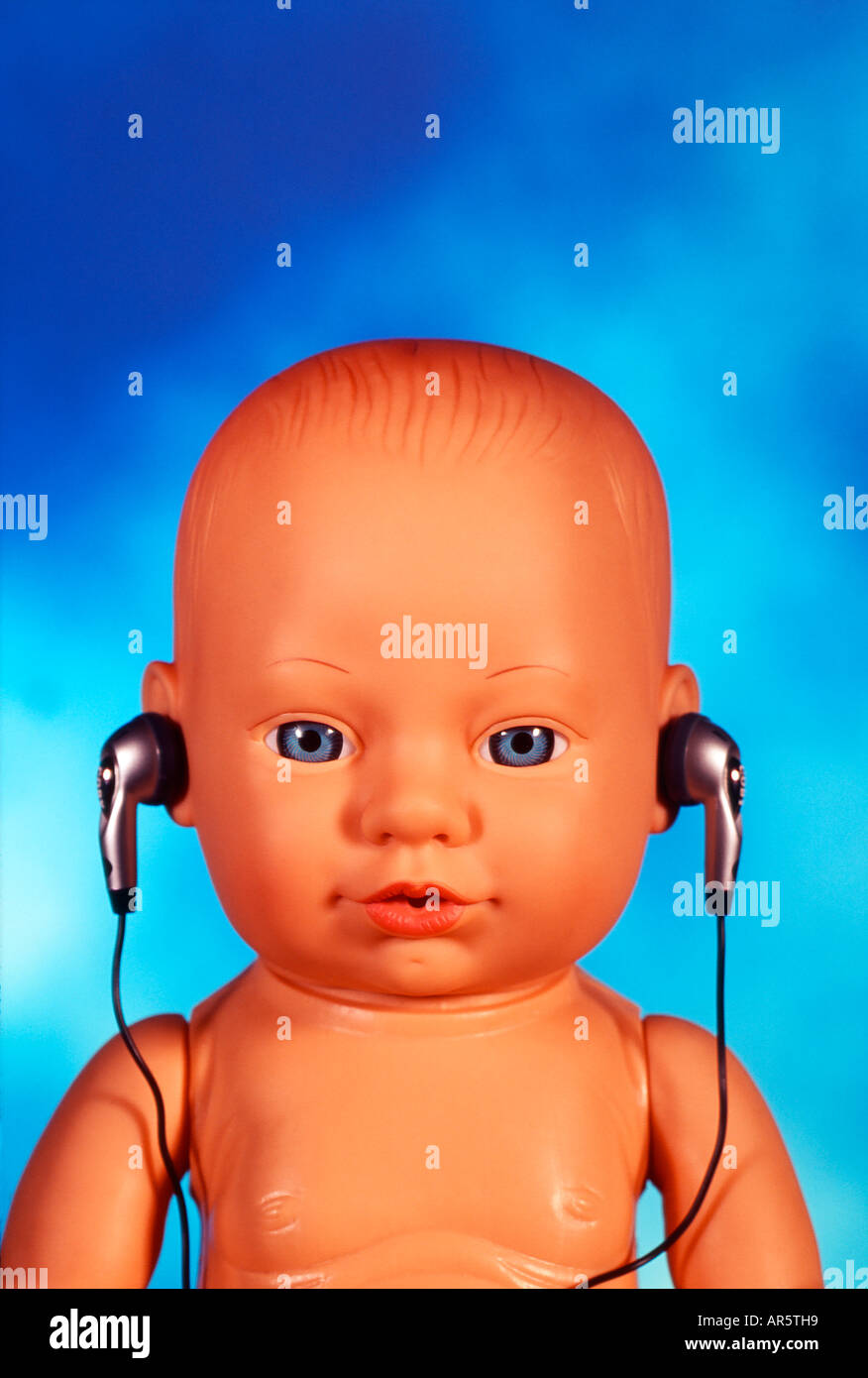 Baby doll wearing headphones Stock Photo Alamy