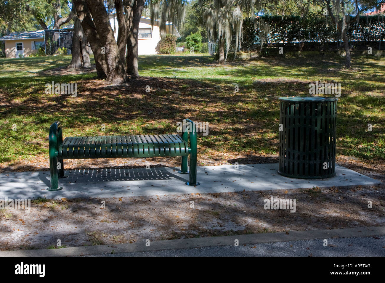 Park bench with trashcan Stock Photo