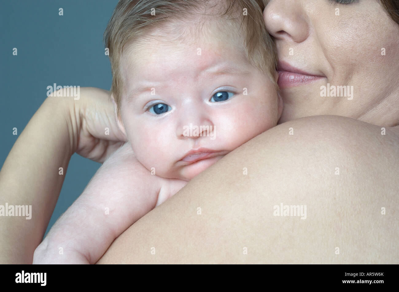 Hispanic mother hugging baby Stock Photo