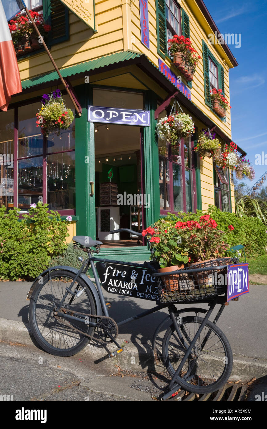 Open sign on old bicycle outside shop in yellow painted wooden