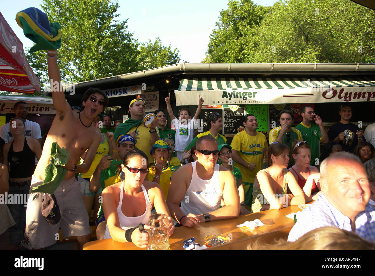 Tourists enjoy the atmosphere of WM live TV at beer garden Munich munchen Bavaria Germany Stock Photo
