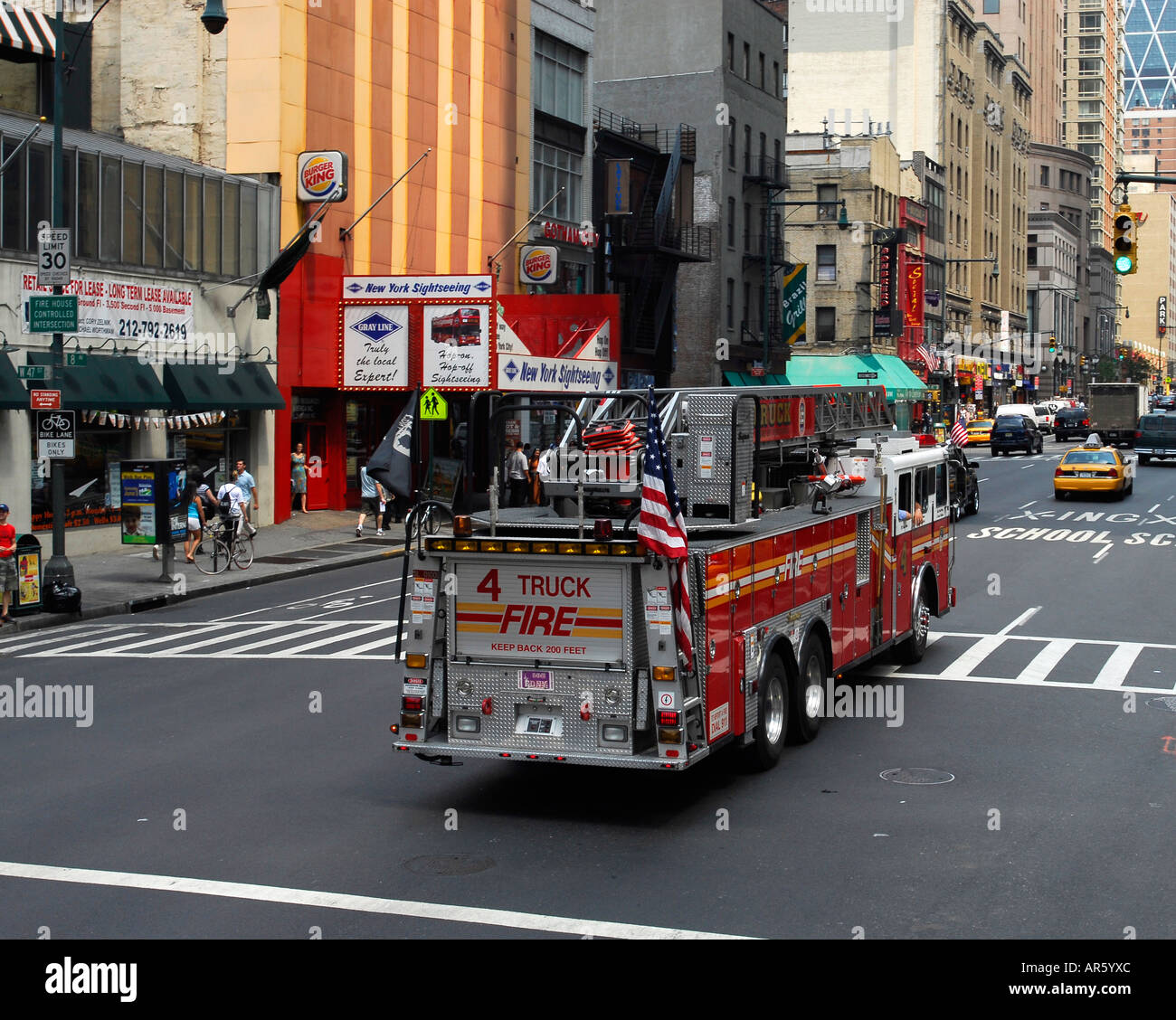 Ladder Truck 4 FDNY Fire department New York drives along eigth avenue