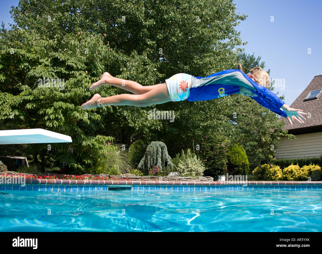 Young girl diving into a swimming pool Stock Photo Alamy