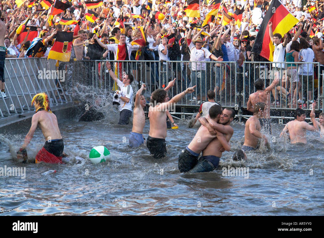 German Football fans celebrate in Olympia lake after winning WM quarter final at Olympia park Munich Bavaria Germany Stock Photo