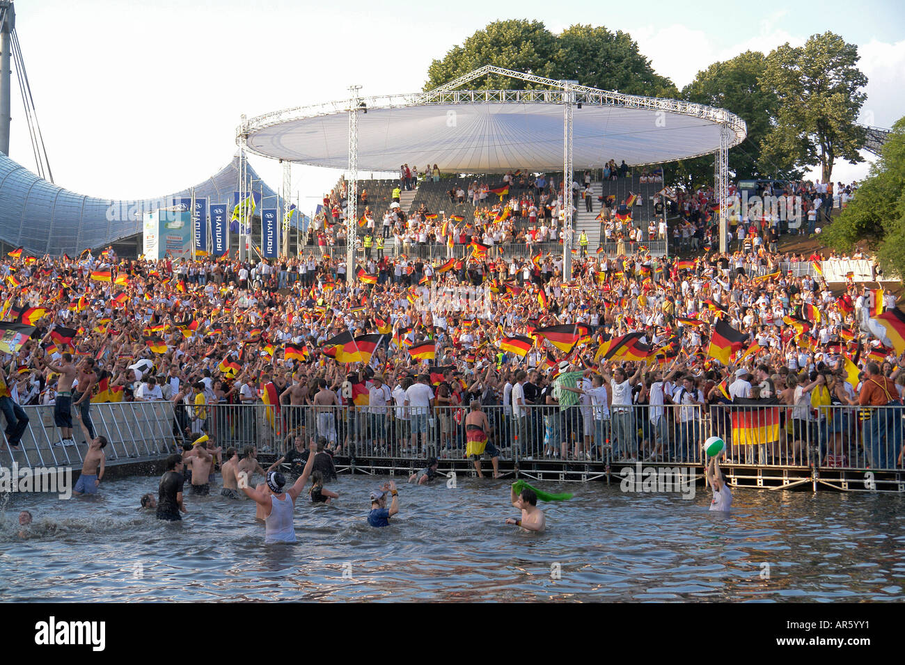 German Football fans celebrate in Olympia lake after winning WM quarter final at Olympia park Munich Bavaria Germany Stock Photo